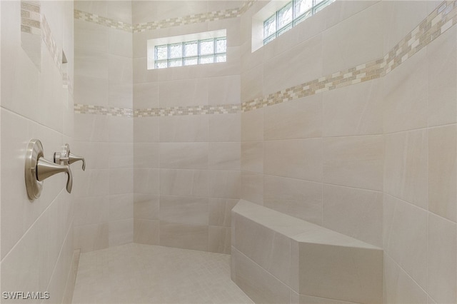 bathroom with a tile shower