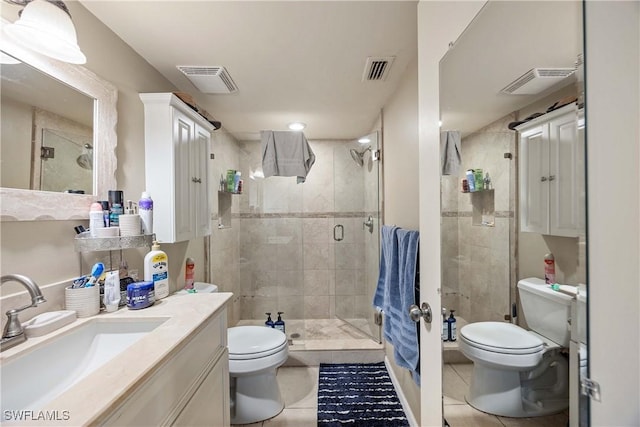 bathroom featuring tile patterned floors, vanity, toilet, and a shower with door