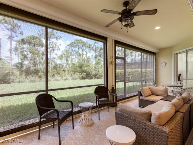 sunroom / solarium featuring ceiling fan