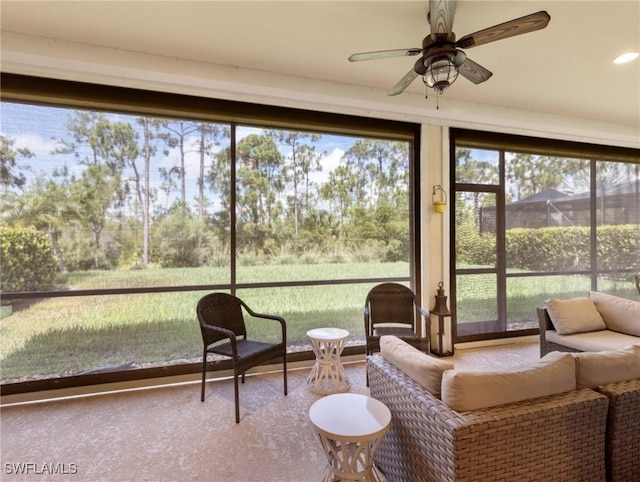 sunroom featuring ceiling fan