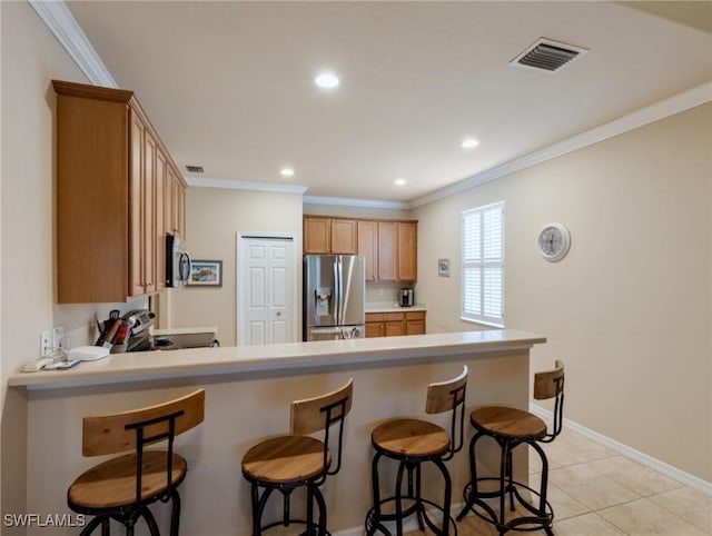 kitchen featuring kitchen peninsula, stainless steel appliances, light tile patterned floors, and ornamental molding