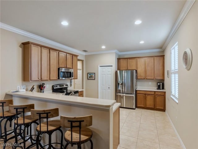 kitchen featuring kitchen peninsula, light tile patterned floors, ornamental molding, and appliances with stainless steel finishes