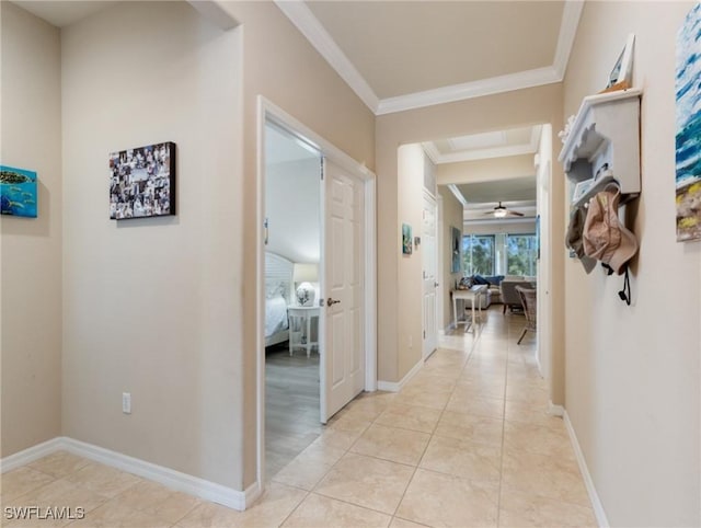 hall featuring light tile patterned flooring and ornamental molding