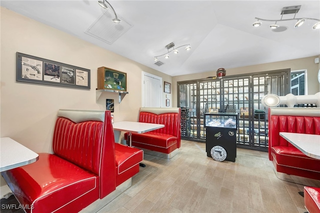 living area with wood-type flooring and vaulted ceiling