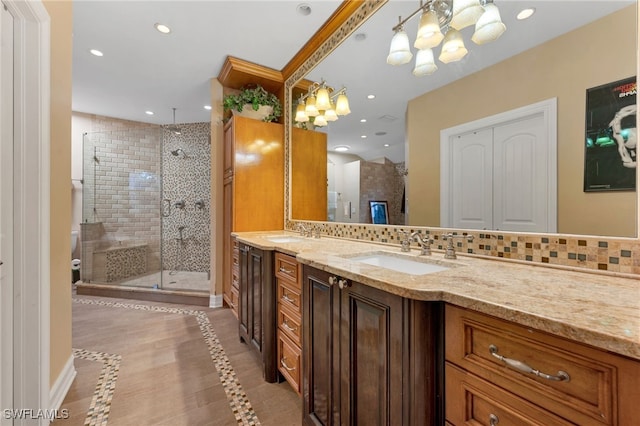 bathroom featuring tasteful backsplash, an enclosed shower, vanity, a notable chandelier, and tile patterned flooring