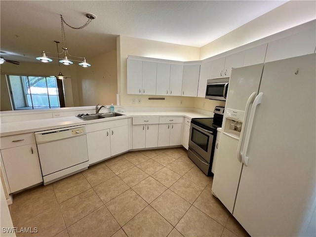 kitchen featuring light tile patterned flooring, appliances with stainless steel finishes, pendant lighting, white cabinetry, and sink