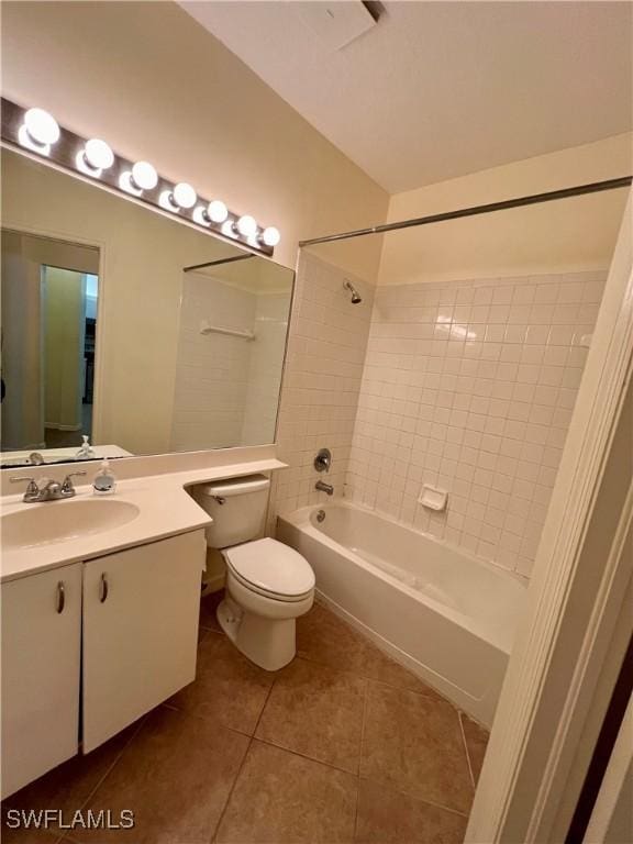 full bathroom featuring vanity, toilet, tiled shower / bath combo, and tile patterned flooring