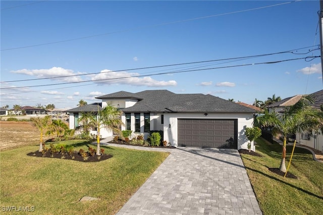 view of front of property featuring a front yard and a garage