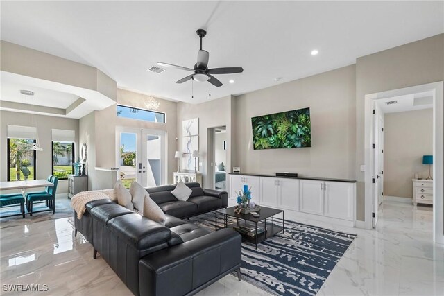 living room with ceiling fan and french doors