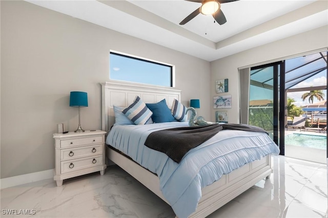 bedroom featuring access to outside, ceiling fan, and a tray ceiling