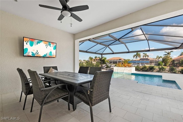 view of patio / terrace with pool water feature, ceiling fan, and a lanai