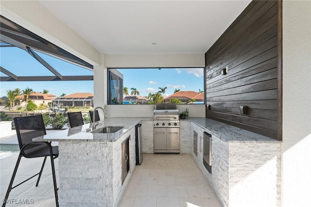 view of patio / terrace featuring area for grilling and an outdoor wet bar