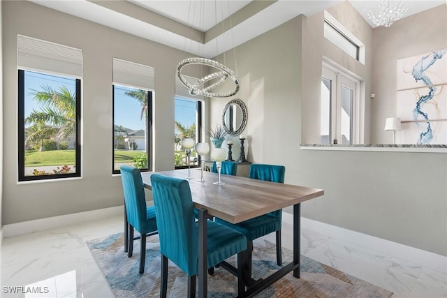 dining room with an inviting chandelier and a healthy amount of sunlight