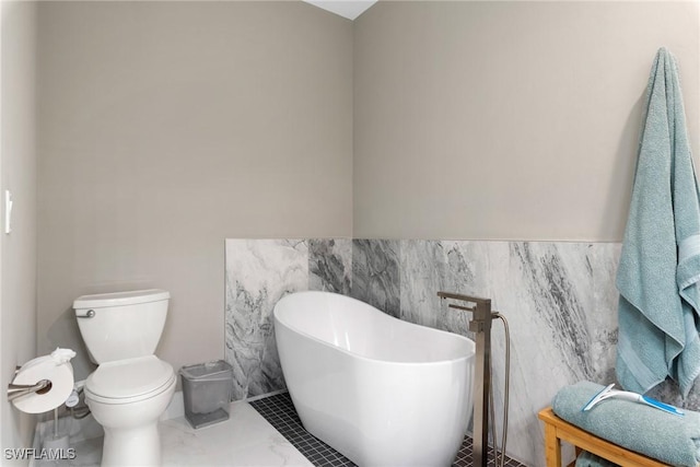 bathroom featuring a tub, tile walls, and toilet