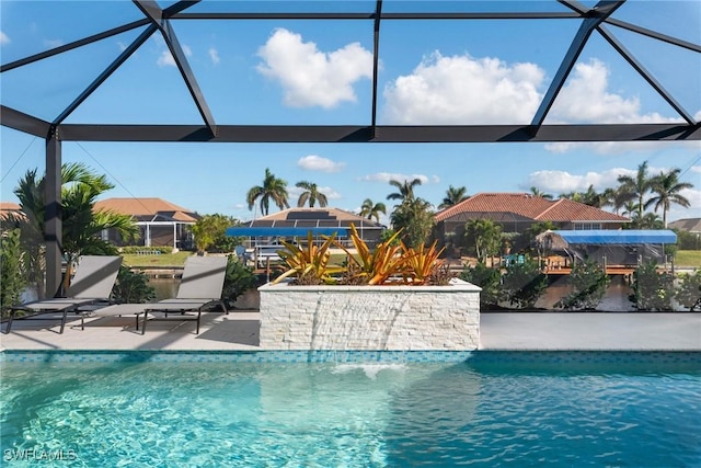 view of pool featuring glass enclosure and a patio area