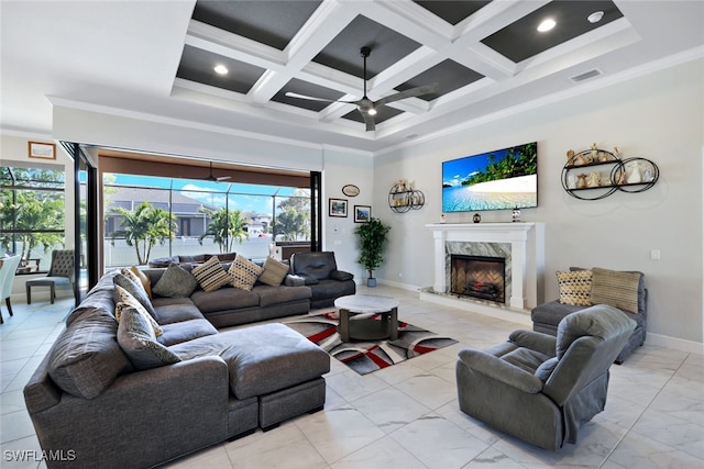 living room featuring coffered ceiling, beam ceiling, ornamental molding, a premium fireplace, and ceiling fan