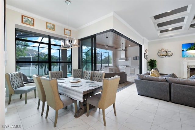 dining room featuring ceiling fan with notable chandelier, a high end fireplace, and ornamental molding