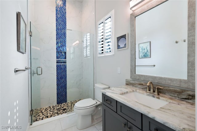 bathroom featuring vanity, a shower with shower door, tile patterned floors, and toilet