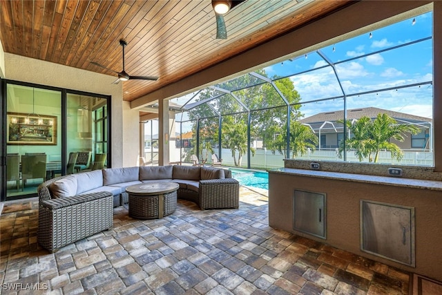 view of patio / terrace featuring glass enclosure and an outdoor hangout area