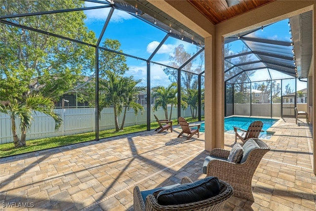 view of patio / terrace with glass enclosure and a fenced in pool