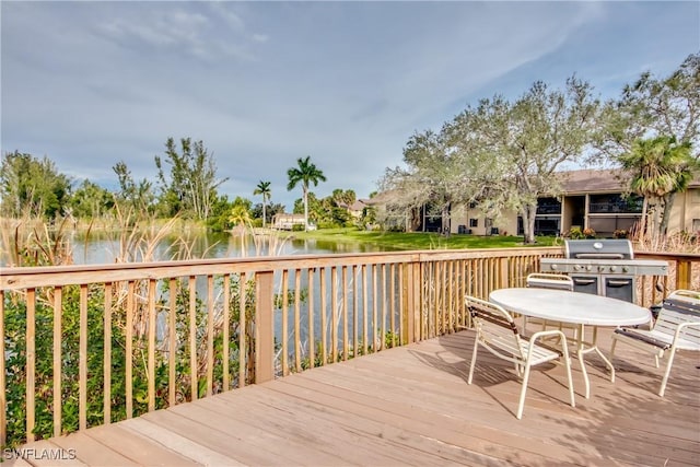 deck featuring a water view and a grill