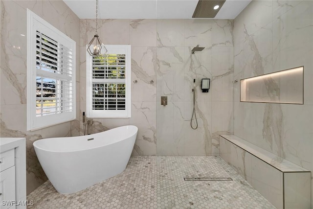 bathroom with vanity, independent shower and bath, and tile walls