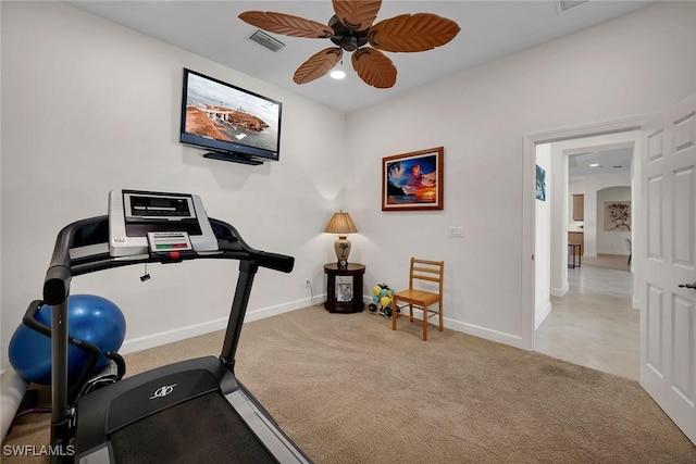 workout area featuring ceiling fan and light carpet