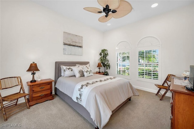 bedroom with ceiling fan and light carpet