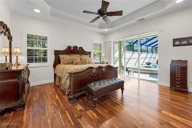 bedroom with crown molding, access to outside, a tray ceiling, dark hardwood / wood-style flooring, and ceiling fan