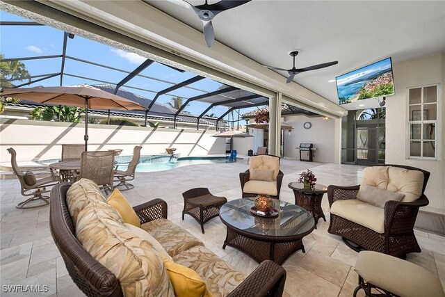 view of patio / terrace with a lanai, ceiling fan, pool water feature, and an outdoor hangout area