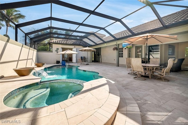 view of swimming pool featuring an in ground hot tub, pool water feature, a patio, and a lanai