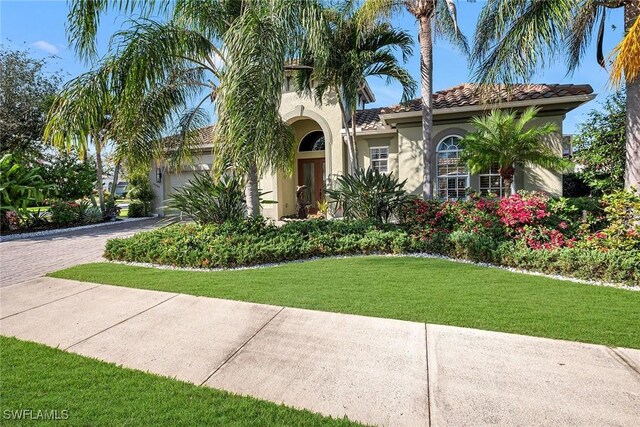 mediterranean / spanish-style home featuring a front lawn