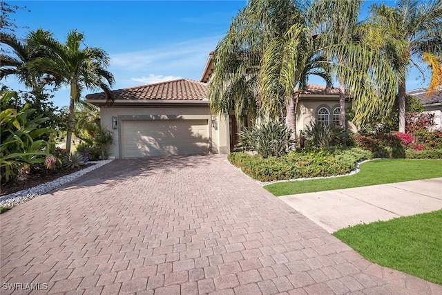 mediterranean / spanish-style house with a garage