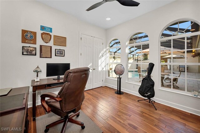 office space with hardwood / wood-style floors and ceiling fan