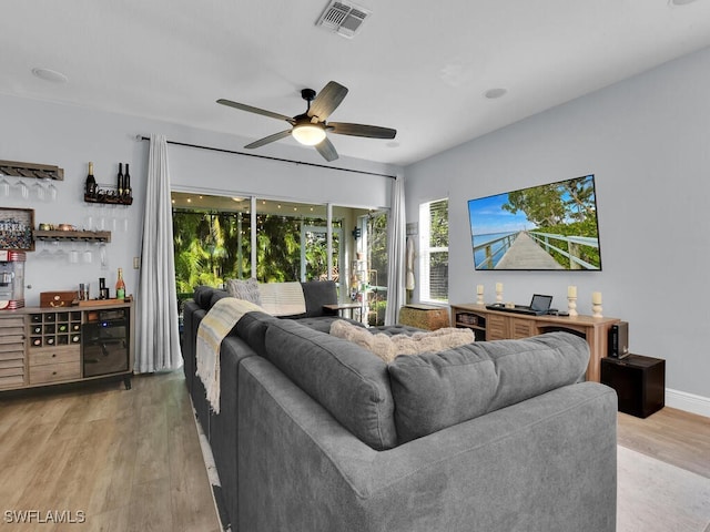 living room featuring light wood-type flooring and ceiling fan