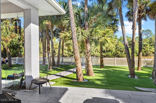 view of home's community with a lawn and a patio area