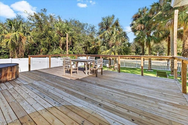 wooden deck featuring a hot tub