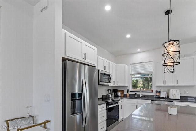 kitchen with white cabinets, pendant lighting, stainless steel appliances, and sink