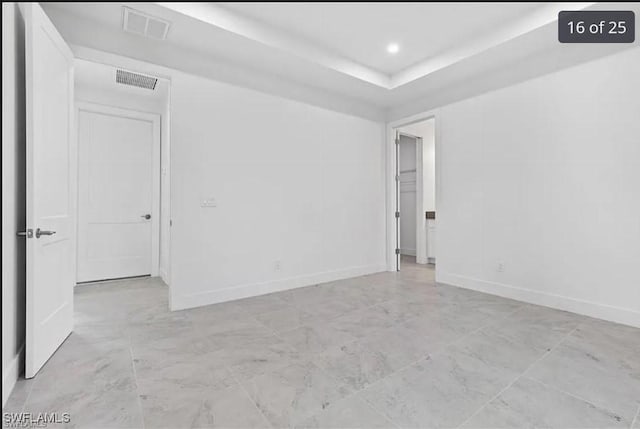 spare room featuring a raised ceiling