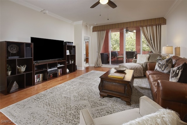 living room with light wood-type flooring, ceiling fan, and ornamental molding