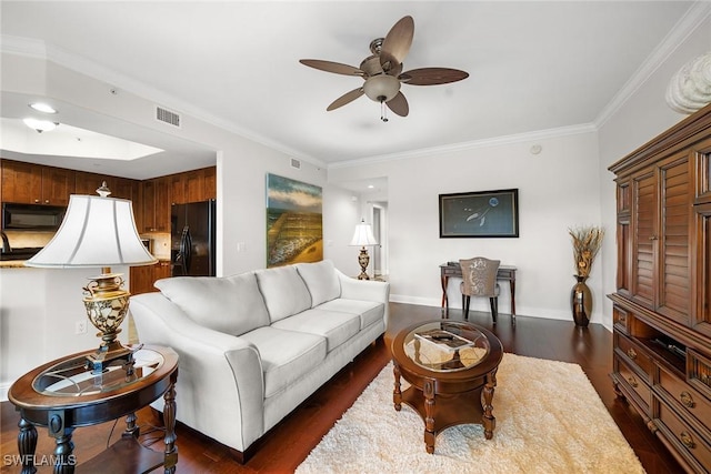 living room featuring dark wood-type flooring, ceiling fan, and crown molding