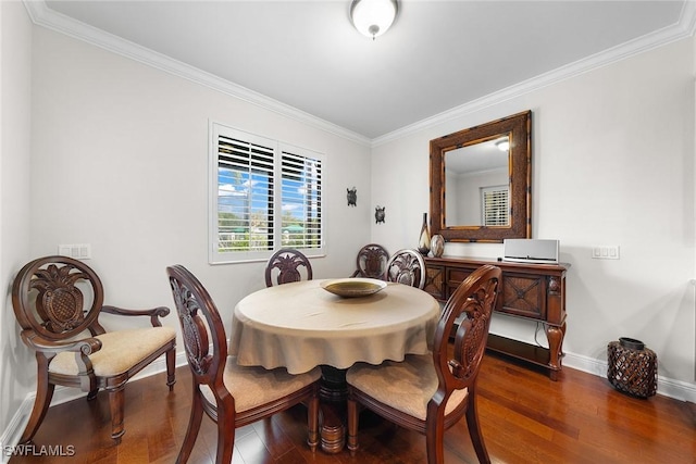 dining area with crown molding and dark wood-type flooring