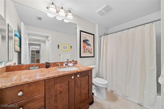 bathroom with tile patterned flooring, vanity, toilet, and walk in shower