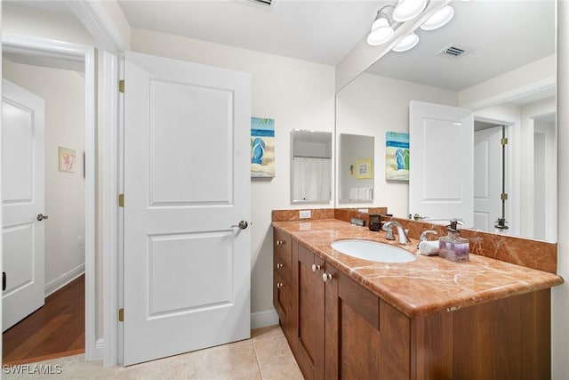 bathroom with tile patterned flooring and vanity