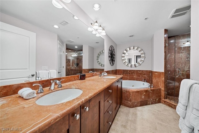 bathroom featuring tile patterned floors, vanity, and shower with separate bathtub