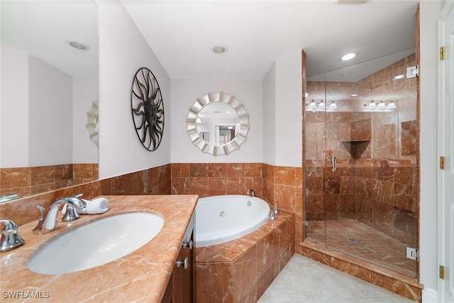 bathroom with tile patterned flooring, vanity, and independent shower and bath