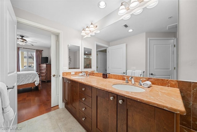 bathroom with ceiling fan, tile patterned flooring, and vanity