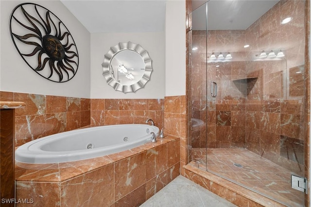 bathroom with tile patterned flooring and separate shower and tub