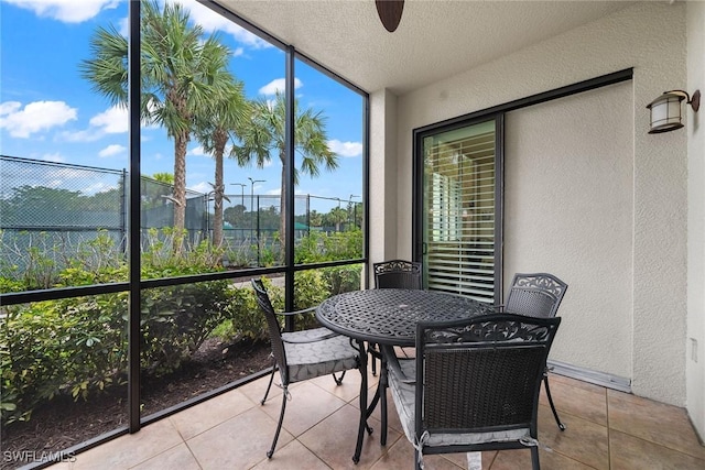 sunroom featuring ceiling fan