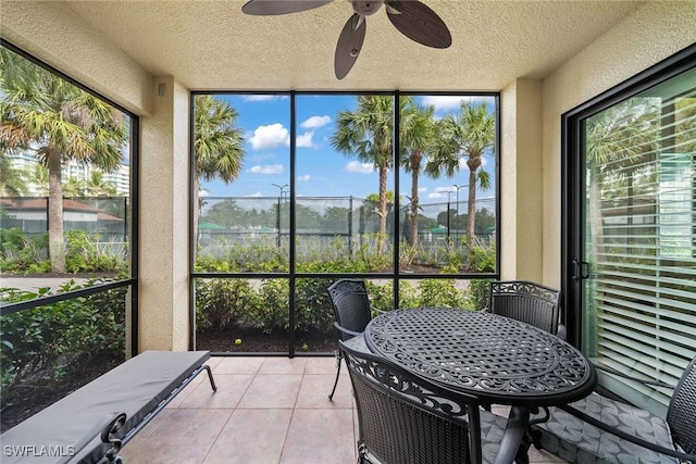 sunroom / solarium featuring ceiling fan